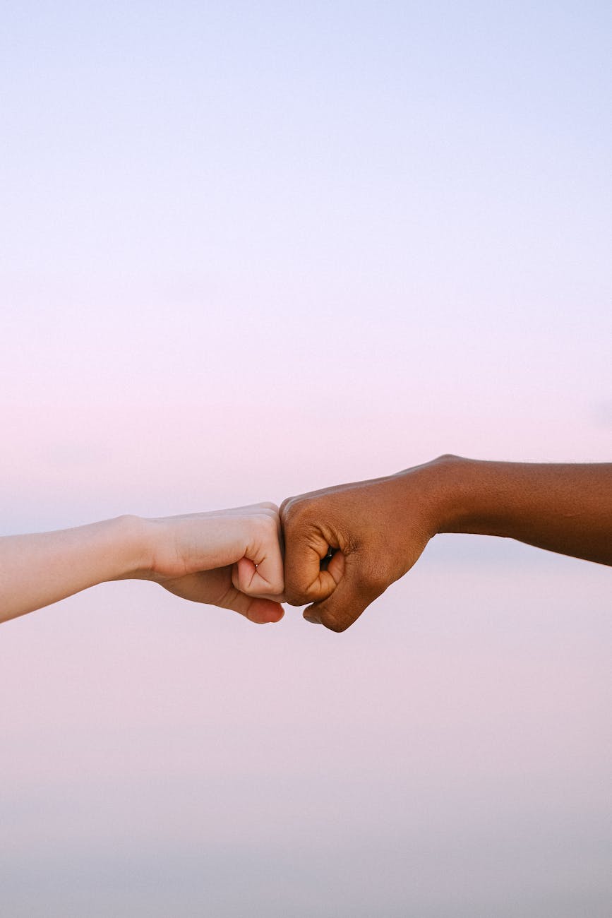 people doing a fist bump